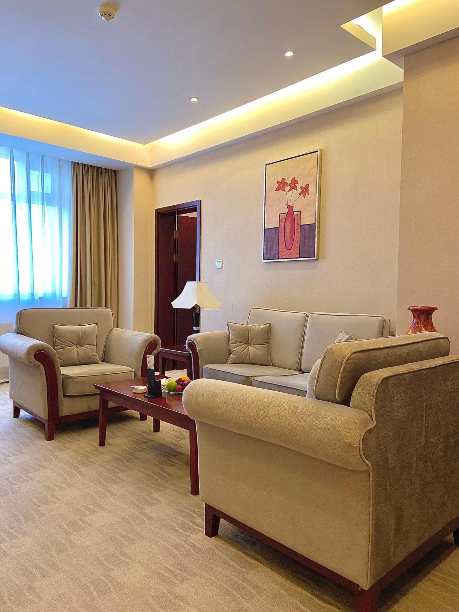 Пекин Палас Soluxe Hotel Astana Экстерьер фото A living room in a suite at the hotel
