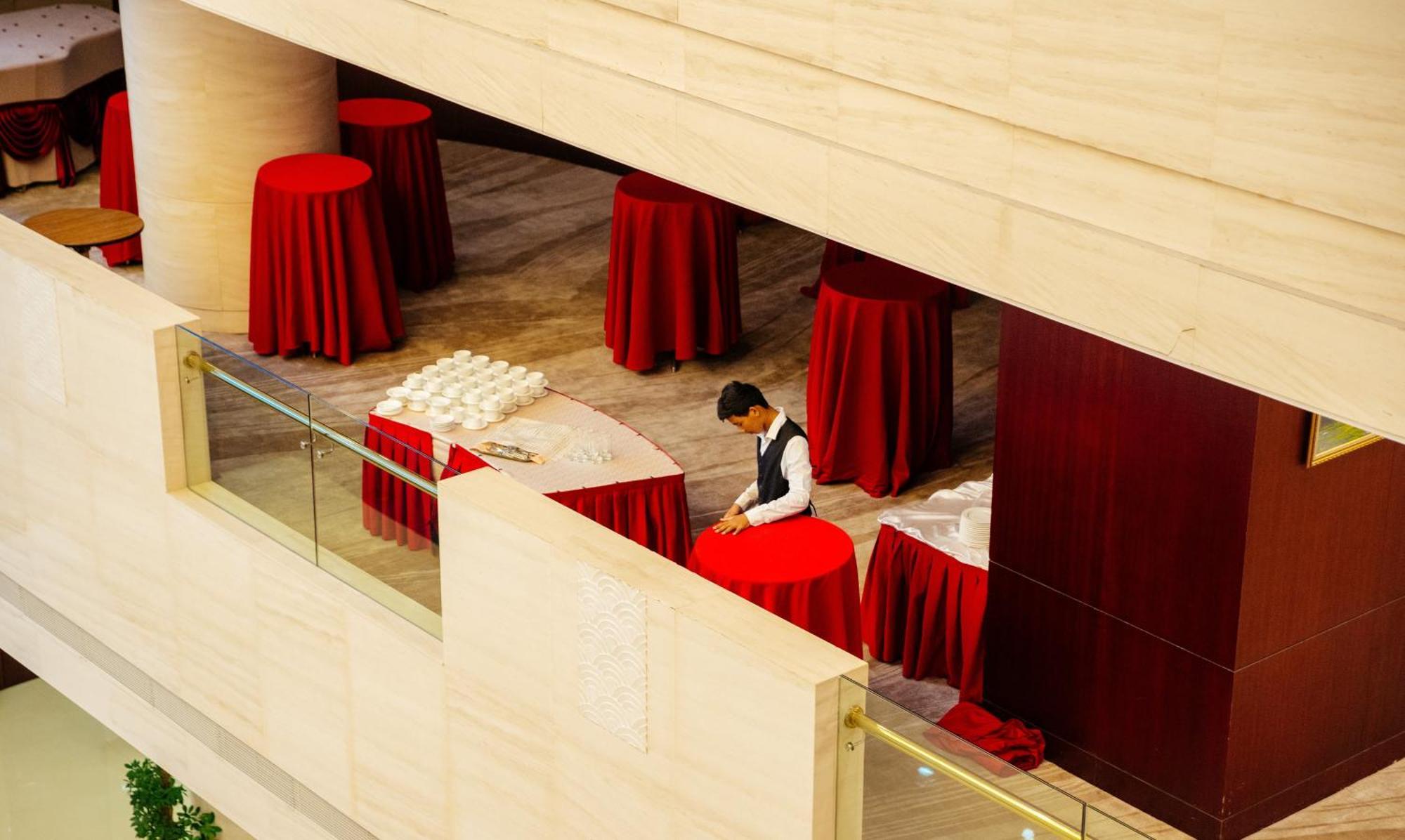 Пекин Палас Soluxe Hotel Astana Экстерьер фото A hotel staff sets up a cocktail reception