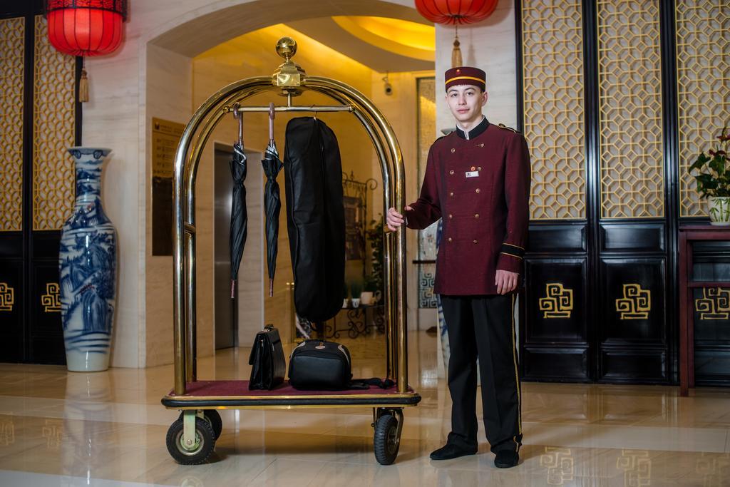 Пекин Палас Soluxe Hotel Astana Экстерьер фото A bellboy with a luggage cart